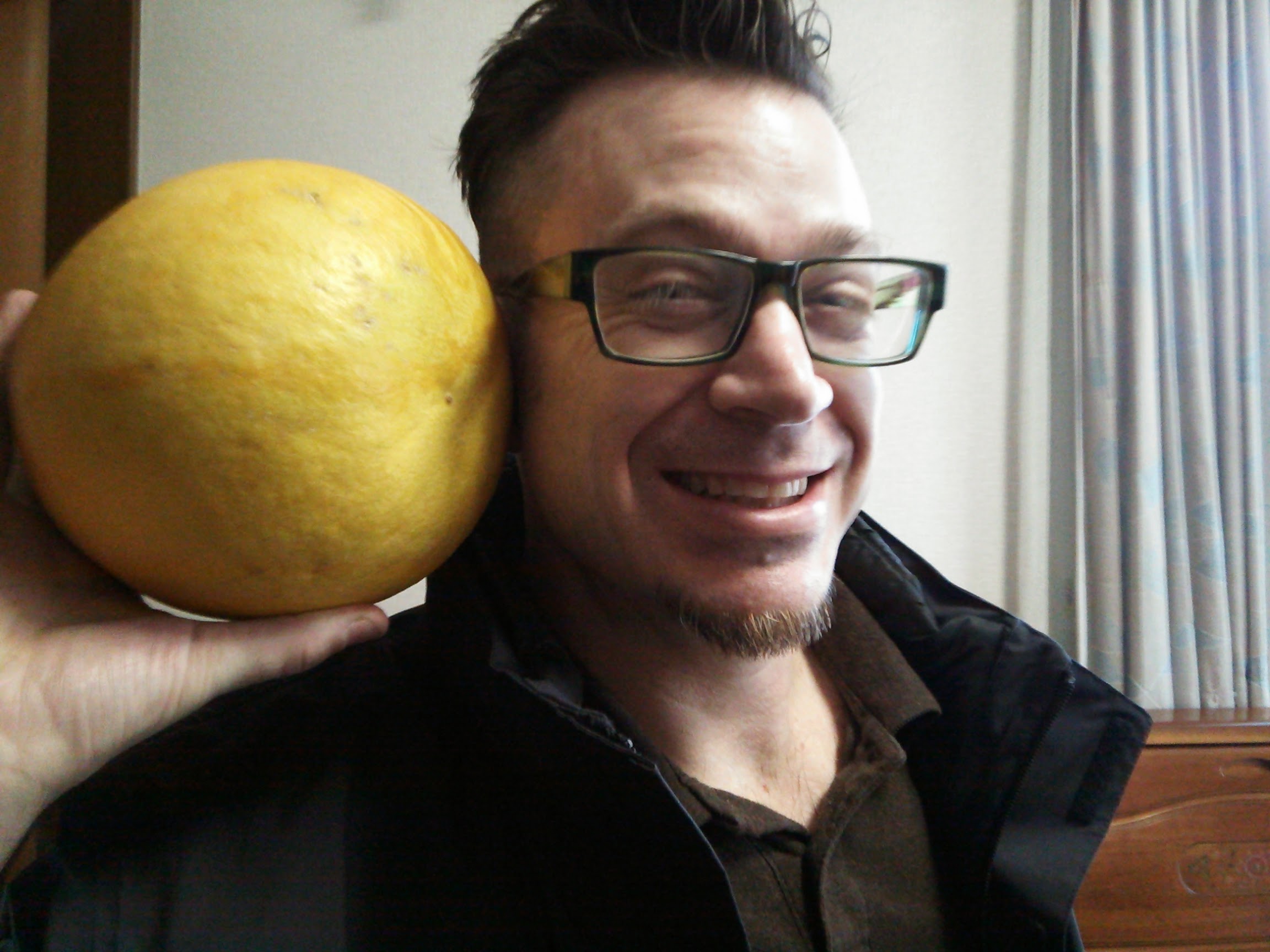 Off-duty in Japan, holding a giant citrus